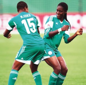 Oshoala (right) celebrates a goal with teammate, Ugo Njoku