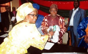 L-R: Iyaloja-General, Folashade Tinubu-Ojo, presenting a gift to former President Olusegun Obasanjo, during a visit by Iyalodes and women leaders from the South-West to Obasanjo in Abeokuta, Ogun State...on Monday | credits: Samuel Awoyinfa