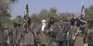 This Friday Oct. 31, 2014 image taken from video by Nigeria's Boko Haram terrorist network, the leader of Nigeria's Islamic extremist group Boko Haram, center, has denied agreeing to any cease-fire with the government and said Friday more than 200 kidnapped schoolgirls all have converted to Islam and been married off. (AP Photo)