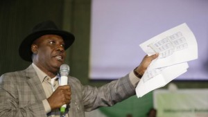 Godsday Orubebe, People's Democratic Party agent, displays what he claims was the final result from the opposition party as he disrupts the announcing of election results accusing the Commission chairman Attahiru Jega, of beimg bias in Abuja, Nigeria, Tuesday, March 31, 2015, Nigerians are waiting in hope and fear for results of the tightest and most bitterly contested presidential election in the nations turbulent history. (AP Photo/Sunday Alamba)