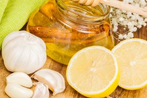Set of alternative remedies for flu treatment including lemon, garlic and honey.